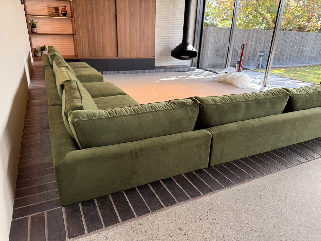 Bespoke olive green custom L-shape lounge handcrafted by Leisure Lounges to fit a sunken architectural living room