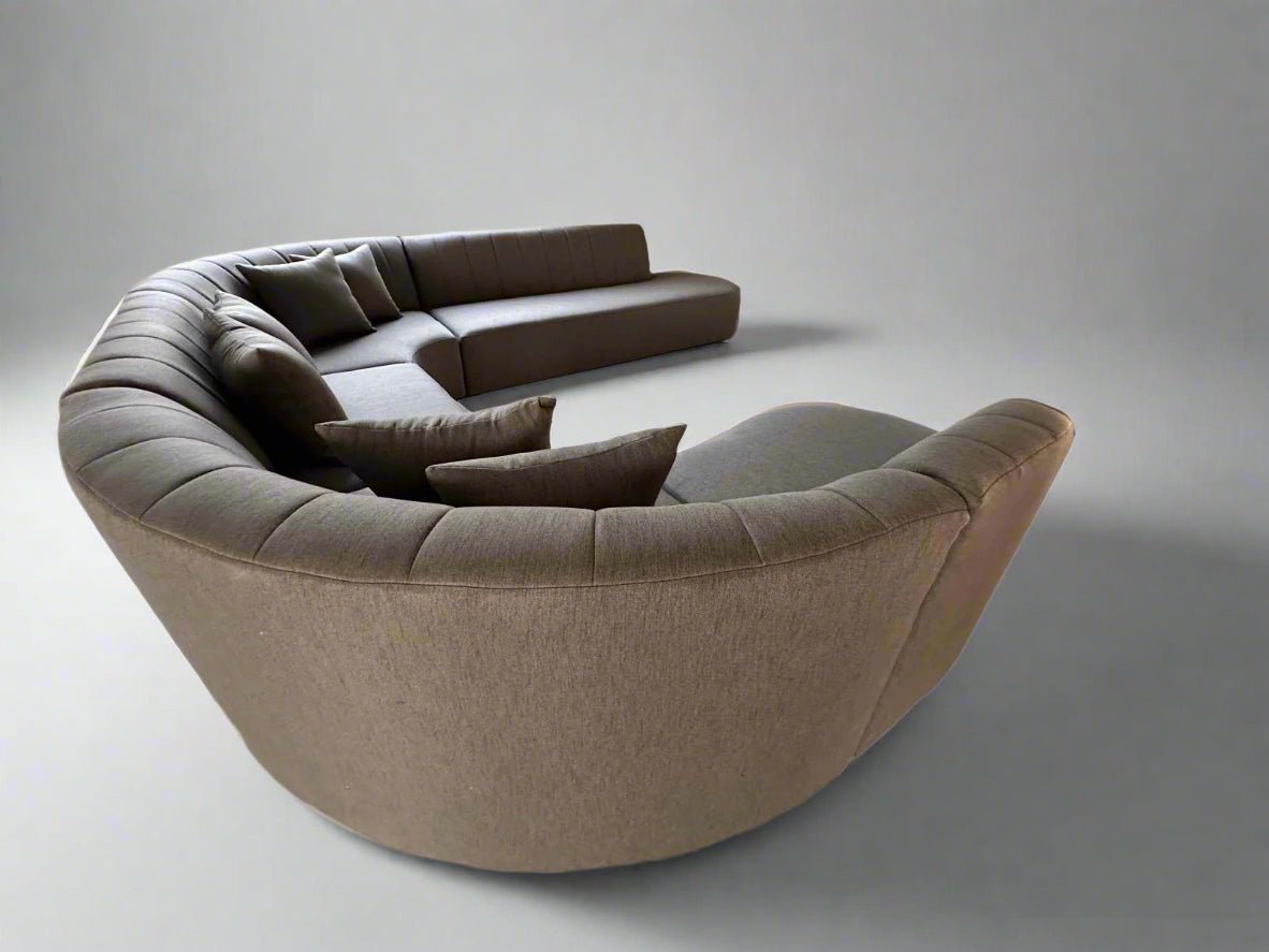 Detailed angle of the Cenna Curved Modular Lounge showing sculptural curved backrest and deep seating.