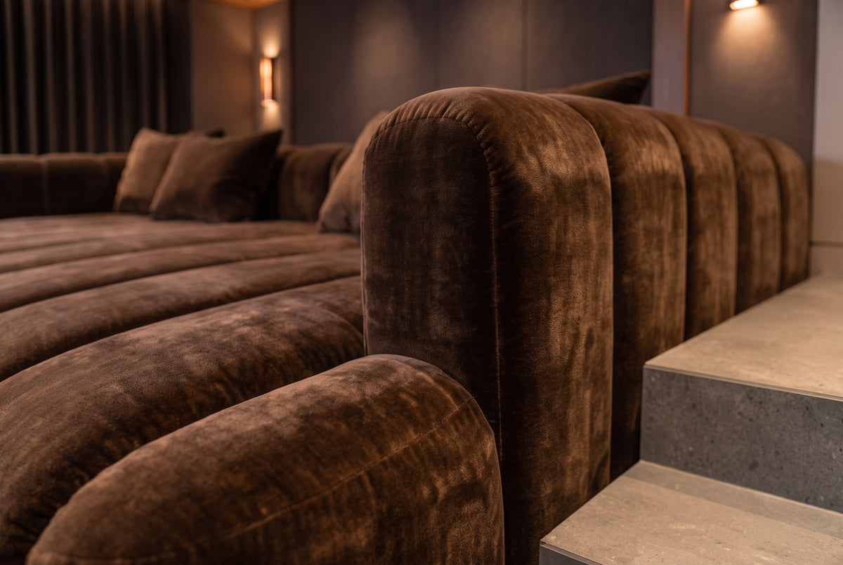 Close-up detail of the Orpheus Theatre Daybed diamond button tufting and piped chocolate velvet upholstery.